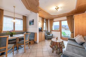 a living room with a couch and a table at Residence Diana Apartment 301 in Terento