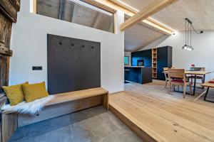 a living room with a couch and a dining room at Chalet Lanthalerhof in San Martino