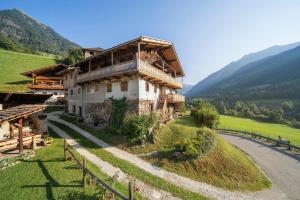 a house on a hill next to a road at Chalet Lanthalerhof in San Martino