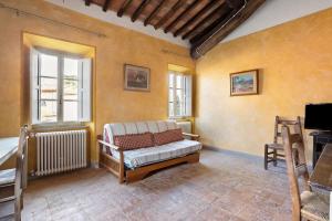 a living room with a couch and a tv at Villa Chelucci - Gualdo in Massarosa