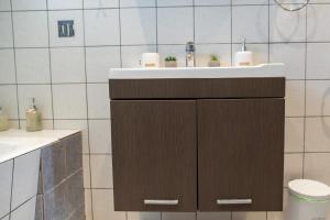 a bathroom with a sink and a toilet at Kos Dream Family Stay in Kos in Zipárion +33 photos