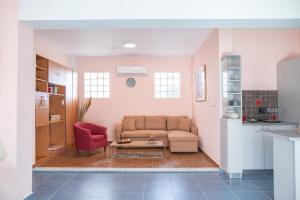 a living room with a couch and a table at Kos Dream Family Stay in Kos in Zipárion