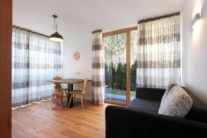 a living room with a couch and a table at Noreia Pitla in Ortisei