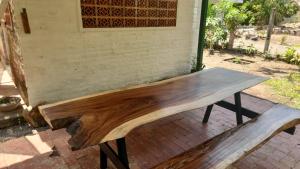 a wooden bench sitting in front of a wall at Mango Soul in El Zonte