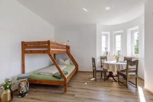 a bedroom with a bunk bed with a table and chairs at Villa Romantika in Ichenhausen