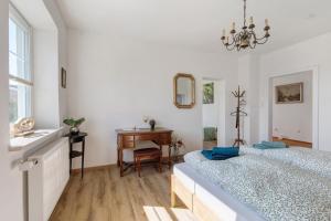 a bedroom with two beds and a desk and a mirror at Villa Romantika in Ichenhausen +58 photos
