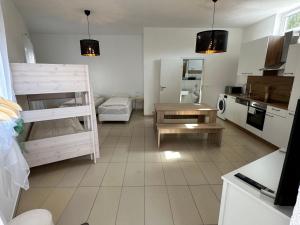 a kitchen with a bunk bed and a kitchen with a table at Dreams Unterkunft in Koetz 