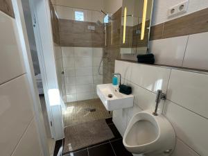 a bathroom with a toilet and a sink at Dreams Unterkunft in Koetz  +2 photos