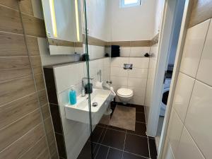 a small bathroom with a sink and a toilet at Dreams Unterkunft in Koetz 