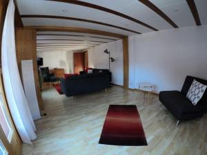 a living room with a couch and a table at Apartment Chalet Nussknacker by Interhome in Lenk