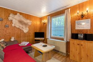 a living room with a couch and a table at Ferienbungalow 1 in Boitzenburg in Boitzenburg