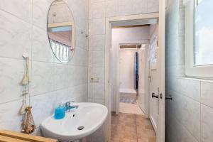 a white bathroom with a sink and a mirror at Ferienbungalow 1 in Boitzenburg in Boitzenburg +18 photos