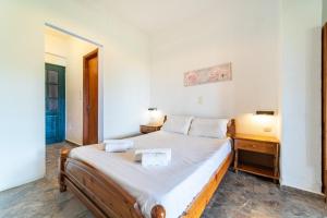 a small bedroom with a bed and a night stand at Arianna Studio Ground Floor 6 in Paleokastritsa