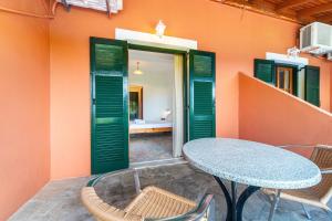 a table and chairs in front of a building at Arianna Studio Ground Floor 6 in Paleokastritsa