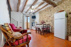 a kitchen and dining room with a white refrigerator at Ca la Llum in Tivissa