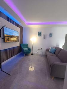 a living room with a couch and a chair at El Ramonal Vacacional in Candelaria