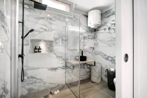 a shower with a glass door in a bathroom at El Ramonal Vacacional in Candelaria +18 photos