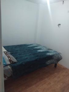 a bed in a corner of a room at Casa de huespedes en el centro in Cajamarca