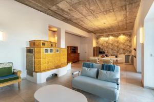 a living room with a couch and a table at Suiten im Alten Berghotel Franziska in Eslohe
