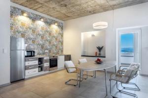 a kitchen with a table and a refrigerator at Suiten im Alten Berghotel Franziska in Eslohe