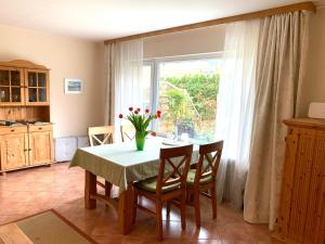 a kitchen with a table with a vase of flowers on it at Ferienwohnung Schmidt Haffkamp in Grömitz