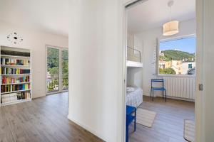 a white room with a bed and a window at Il Borgo Incantato con garage in Finale Ligure
