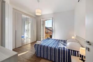 a bedroom with a bed and a large window at Il Borgo Incantato con garage in Finale Ligure