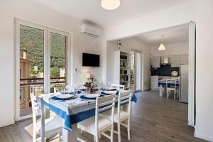 a dining room and kitchen with a table and chairs at Il Borgo Incantato con garage in Finale Ligure