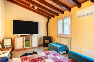 a living room with a flat screen tv on the wall at Residence Al Pozzo in Capannori