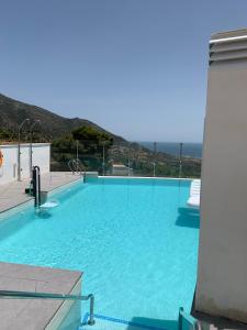 a large swimming pool with a view of the ocean at Central Apartment with a view in Mijas