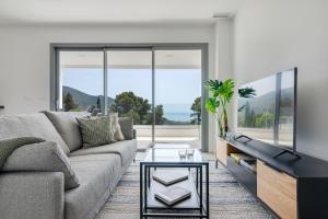 a living room with a couch and a table at Central Apartment with a view in Mijas