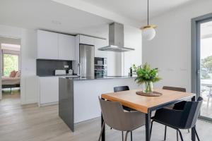 a kitchen and dining room with a wooden table and chairs at Central Apartment with a view in Mijas