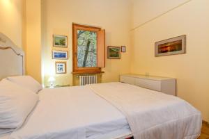 a bedroom with a white bed and a window at Colleincanto Appartamento Vittorio in Gavardo +22 photos