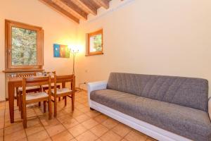 a living room with a couch and a table at Colleincanto Appartamento Vittorio in Gavardo
