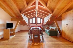 a dining room with a table and a couch at Agriturismo Soleil Levant Torgnon in Torgnon
