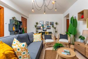 a living room with a blue couch and chairs at Home Centrum 2 in Giarre