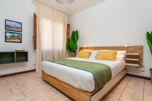 a bedroom with a large bed and a tv at Home Centrum 2 in Giarre