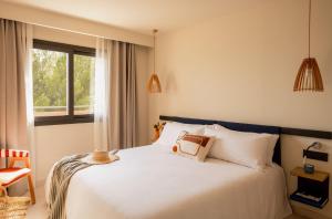 a bedroom with a white bed and a window at Zel Costa Brava in Tossa de Mar +118 photos