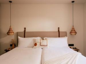 a bedroom with two beds with white pillows at Zel Costa Brava in Tossa de Mar