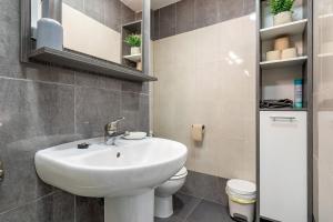 a bathroom with a sink and a toilet at Sonrisita in Miami Platja +18 photos