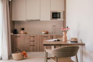 a kitchen with a table with chairs and a sink at Zel Costa Brava in Tossa de Mar