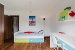 a white bedroom with a bed and a desk at Paradise Villa in Esposende +26 photos