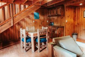 a dining room with a table and chairs at Cumbres Hotel y Cabañas in Gómez Farías