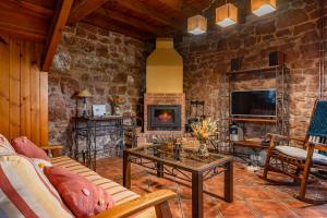 a living room with a couch and a fireplace at La Pumarada in Villaviciosa