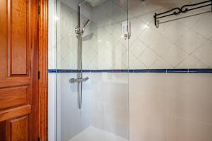 a bathroom with a shower with a glass door at La Pumarada in Villaviciosa +16 photos