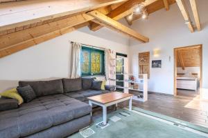 a living room with a couch and a table at Blockhaus - Ferienwohnung Sunset in Erdmannsdorf