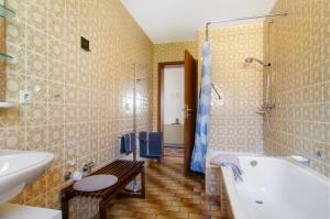 a bathroom with a tub and a toilet and a sink at Vronis Ferienwohnungen in Mühlingen +73 photos
