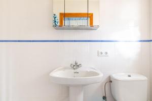 a white bathroom with a sink and a toilet at Son Amanada in Santa Margalida +20 photos