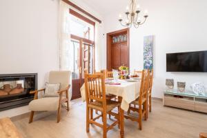 a dining room with a table and chairs and a fireplace at Son Amanada in Santa Margalida