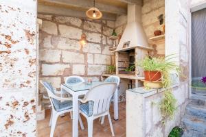 an outdoor kitchen with a table and chairs at Son Amanada in Santa Margalida